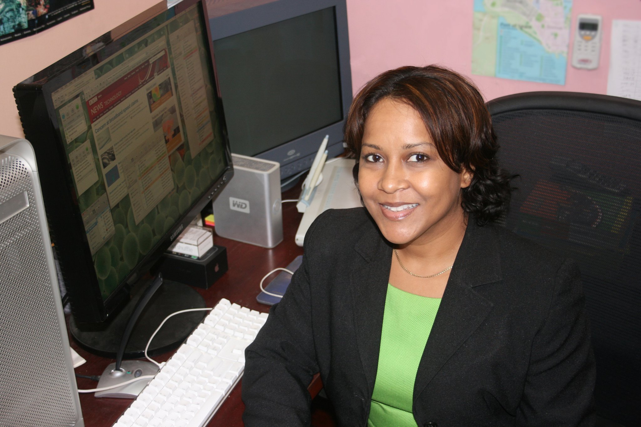 Maria Mohammed-Maharaj seated at her desk in the KAMO office in 2011